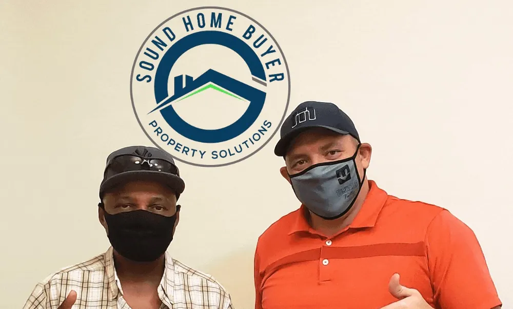 Ryan Garrison and a seller giving thumbs up on closing day